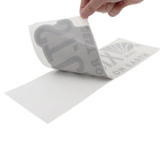 Hand pulling back the transfer paper on a st. croix decal.