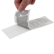 Hand pulling back a grey st croix fly decal off of paper.