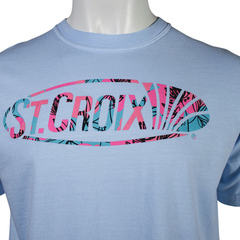 Close up of a light blue short-sleeve t-shirt on a white mannequin torso, featuring a large 'ST. CROIX' graphic across the chest in a pink, teal, and black tropical leaf patterns.