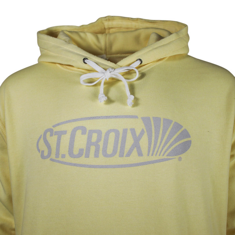 Close-up of a pale yellow pullover hoodie with white drawstrings and a gray 'ST. CROIX' logo printed across the chest.
